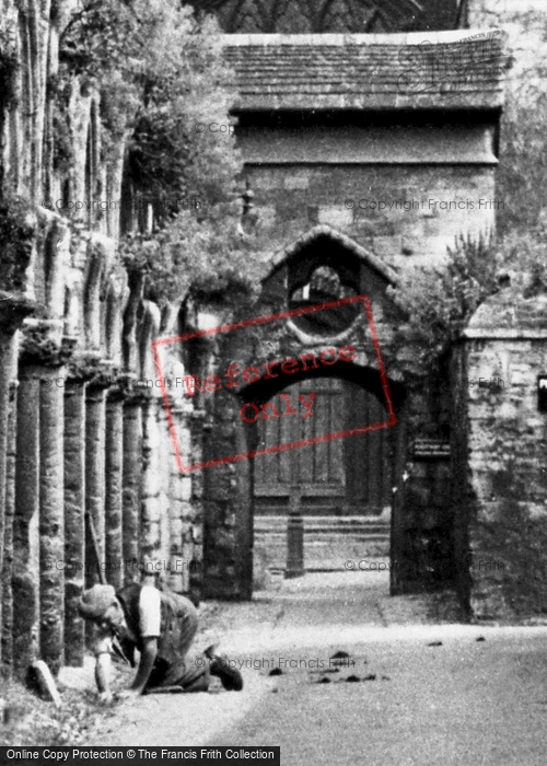 Photo of Peterborough, Weeding The Cathedral Slype c.1955