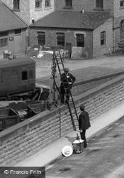 Station, Men Fixing Lamp 1909, York